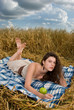Beautiful slavonic girl on picnic in wheat field with apple