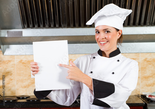 Photo: chef holding a white board or menu in kitchen chef holding a white board or menu in kitchen