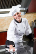 pretty female chef wiping kitchen counter