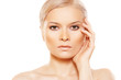 Beautiful woman with natural make-up touching her face
