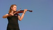 young woman plays violin against blue sky young woman plays violin against blue sky