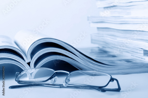 Photo: Open journals with glasses Open journals with glasses