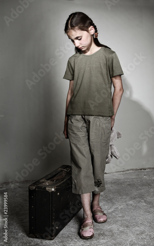 Photo: Little lonely girl with suitcase Little lonely girl with suitcase
