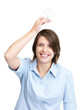 Beautiful young woman holding light bulb over head
