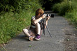 boy taking pictures with tripot of leafes in detail