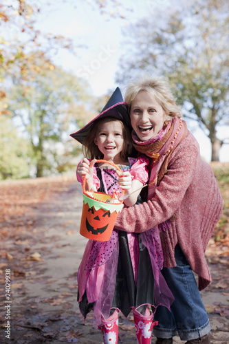 Photo: Grandmother hugging granddaughter in Halloween costume Grandmother hugging granddaughter in Halloween costume