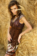 Young attractive woman in a haystack