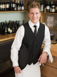 Waiter leaning on counter in restaurant