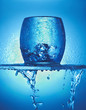 "Close up of blue glass, ice cubes and dripping water"