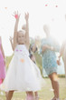 Flower girl catching bouquet at wedding reception