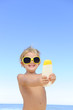 Photo : child with sunglasses showing suncream child with sunglasses showing suncream