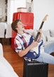 Man strumming guitar and singing