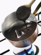 melting dark chocolate in a copper saucepan