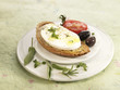 mozzarella with herbs on toast with tomato and olives