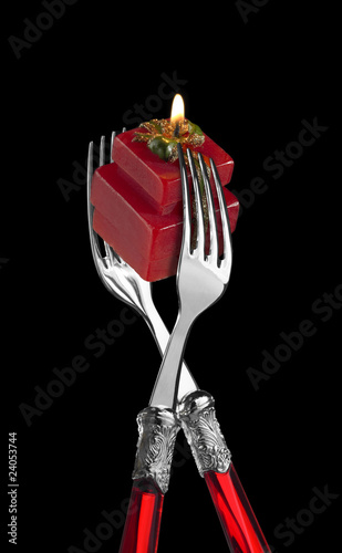 Photo: two forks with present-shaped candle two forks with present-shaped candle