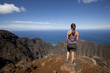 Woman on mountain top viewing ocean