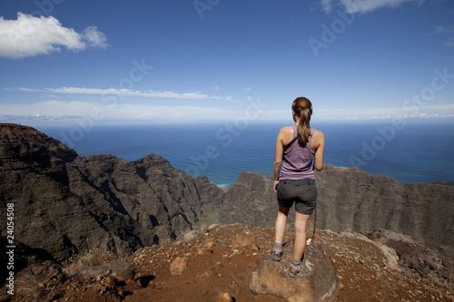 Photo: Woman on mountain top viewing ocean Woman on mountain top viewing ocean