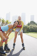 Friends on rollerblades on park