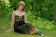 Beautiful young woman sat in woodland Beautiful young woman sat in woodland