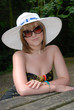 Pretty woman with white hat and glasses Pretty woman with white hat and glasses