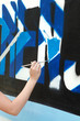Making graffiti, hand with brush and wall Making graffiti, hand with brush and wall