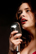 Beautiful singer singing with microphone