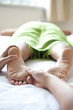 Woman receiving foot reflexology by therapist