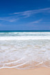 Beautiful beach with crashing waves in the tropics