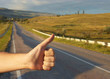 Hand of hiker man at rural mountain road. Daybreak.