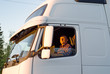 Foto: The driver in a cabin of the truck The driver in a cabin of the truck