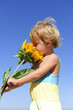 Photo : Cute child smelling a sunflower Cute child smelling a sunflower