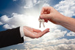 Male Handing Keys to Female Over Clouds and Rays Male Handing Keys to Female Over Clouds and Rays