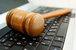 Gavel on a laptop computer close up Gavel on a laptop computer close up