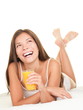 Woman in bed drinking Juice