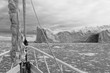BW Sailing boat in Antarctic waters with majestic landscape