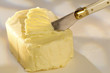 knife srapping the pat of butter