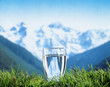 glass of water with mountains in the background