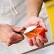 taking the ends off a slice of red pepper