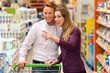 couple in supermarket with shopping cart
