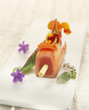 teriyaki salmon brochette with edible flowers