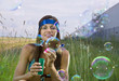 Foto: woman blows soap bubbles woman blows soap bubbles