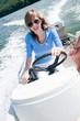 Young girl driving motorboat