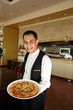 waiter holding pizza