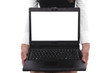 Young sitting woman holding a laptop with the white screen Young sitting woman holding a laptop with the white screen