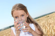 Closeup of little blonde girl drinking wtaer