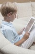 Photo: Boy reads a digital book Boy reads a digital book