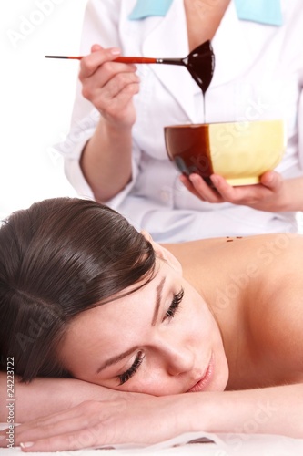 Photo: Young woman having chocolate body mask. Young woman having chocolate body mask.