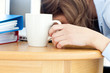 Dozy woman sleeping on table in office