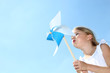 Closeup of little girl blowing blue wind wheel Closeup of little girl blowing blue wind wheel