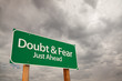 Doubt and Fear Green Road Sign Over Storm Clouds